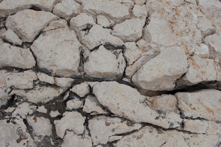 beige background natural stone with cracks macro view