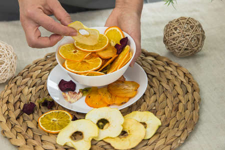 plate with dried fruits in hand