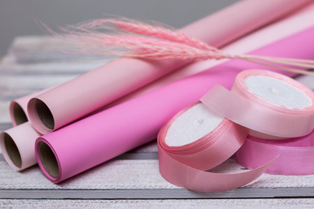 pink paper for wrapping gifts and goods.colored paper for bouquets.wrapping paper and pink ribbon for floristry.gift wrapping paperの写真素材