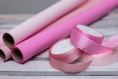 pink paper for wrapping gifts and goods.colored paper for bouquets.wrapping paper and pink ribbon for floristry.gift wrapping paperの写真素材