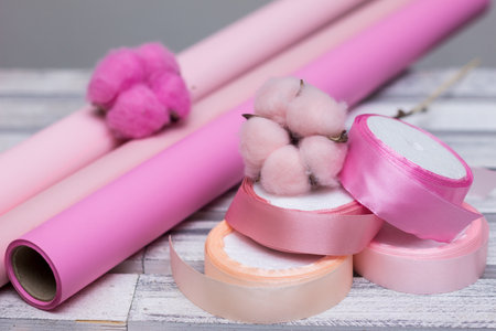 pink paper for wrapping gifts and goods.colored paper for bouquets.wrapping paper and pink ribbon for floristry.gift wrapping paperの写真素材