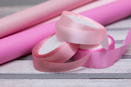 pink paper for wrapping gifts and goods.colored paper for bouquets.wrapping paper and pink ribbon for floristry.gift wrapping paperの写真素材