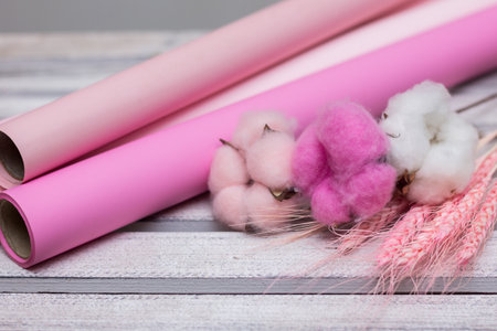 pink paper for wrapping gifts and goods.colored paper for bouquets.wrapping paper and pink ribbon for floristry.gift wrapping paperの写真素材