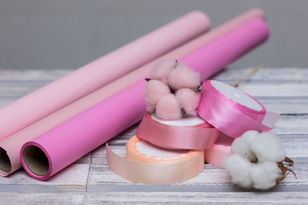 pink paper for wrapping gifts and goods.colored paper for bouquets.wrapping paper and pink ribbon for floristry.gift wrapping paperの写真素材