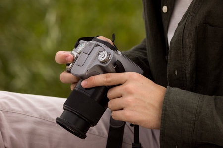 Camera close-up.Camera in hand.Photography training.Man looking at the camera.Camera photography...