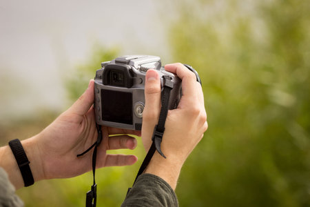 Camera close-up.Camera in hand.Photography training.Man looking at the camera.Camera photography...