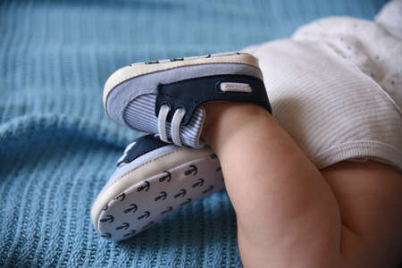 Babys legs in stylish sneaker booties in the summerの写真素材