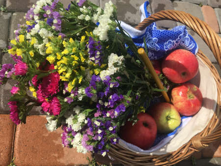 Basket with apples, bouquet and candle for the church holiday Apple Saviorの写真素材