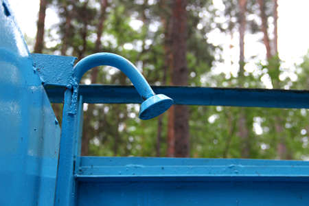 Old shower with peeling blue paint in the forest outdoorsの写真素材