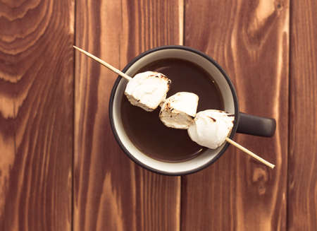 Mug filled with hot chocolate and marshmallows on wooden backgroundの写真素材