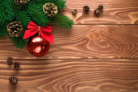 Christmas fir tree with decoration on dark wooden board. Soft focus. Happy New Year!の写真素材