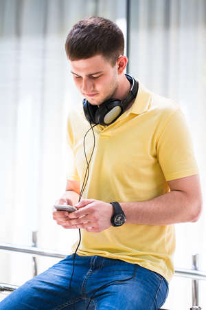 Teenage Boy Wearing Headphones And Listening To Music In Urban Settingの写真素材