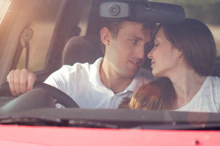 young smile couple romantic kissing sitting in car , summer seasonの写真素材