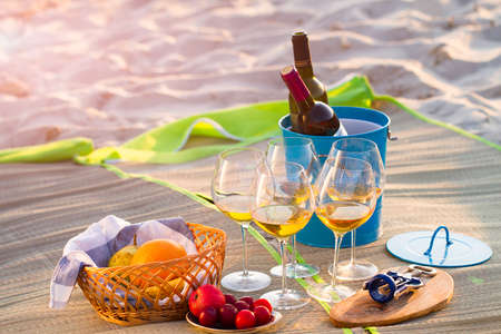 Glasses of the white wine on the beach, picnic themeの写真素材