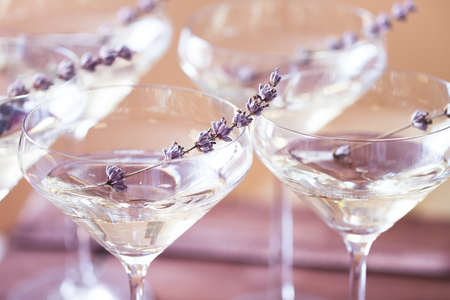 Glasses of with white champagne decorated with lavender on blurred background. DOFの写真素材