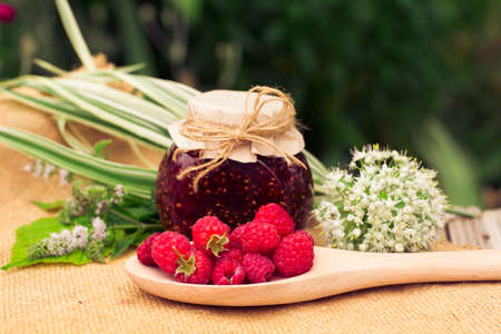 Fresh raspberries and jam on wooden table. Selective focusの写真素材