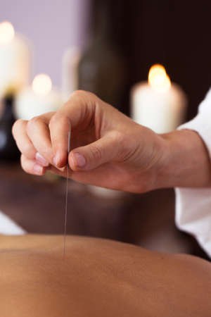 Beautiful young woman relaxing with hand massage at beauty spa. Close-upの写真素材
