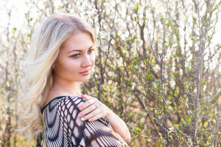 beautiful girl in the garden on a sunny dayの写真素材