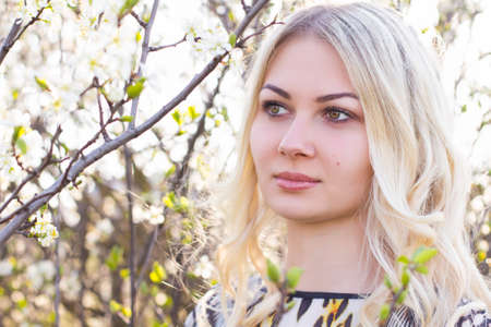 beautiful girl in the garden on a sunny dayの写真素材