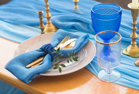 Wedding dinner table detail in white, gold and blue color. Selective focus. DOFの写真素材
