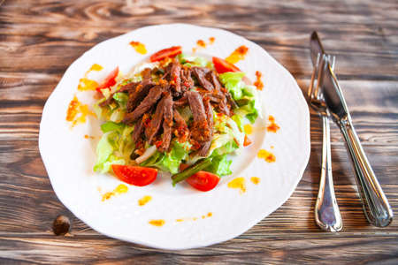 Tasty spice Mexican salad with meat and vegetables on white plateの写真素材