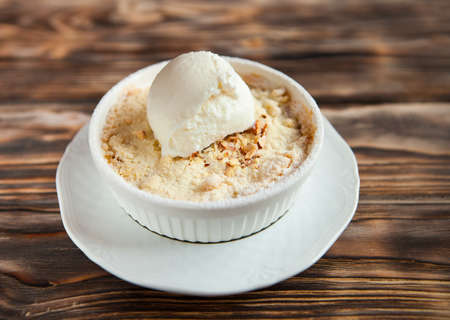 Tasty dessert with an ice cream ball on dark wooden backgroundの写真素材