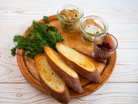 Smoked chicken and soft cheese spread, mousse, pate in a jar with crackers, on a wooden background. Top viewの写真素材