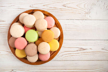 Colorful macaroons on white vintage table, with copy space, close upの写真素材