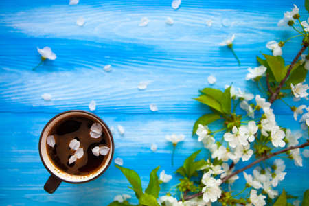 A cup of coffee on blue wood spring background. Selective focusの写真素材