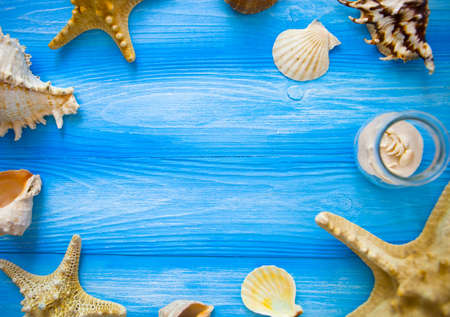 Sea frame. Different marine items on blue wooden background. Sea objects on wooden planks. Selective focus. Place for text.の写真素材