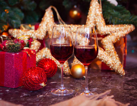 Two glasses of red wine on a Christmas tree background, Xmas Tree Decoratedの写真素材