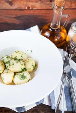 Hot boiled potato with green on rustic backgroundの写真素材