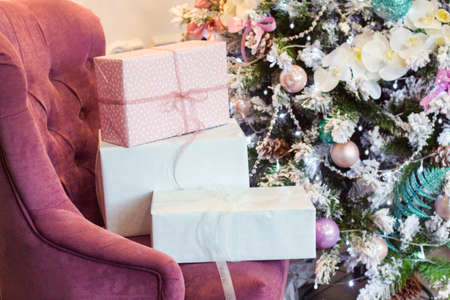 Decorated Christmas tree and gift box in the interior. Soft focus, close upの写真素材