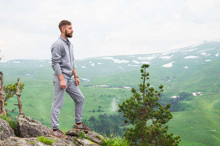 Portrait Hipster Man on top of mountain. Conceptual design.の写真素材