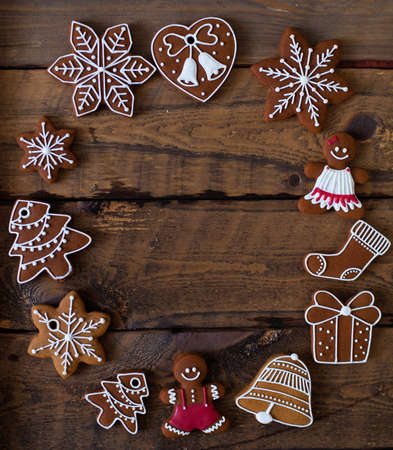 Christmas composition. Xmas cookies, Gingerbread man, tangerines, cinnamon, festive decoration, fir branches on dark old wooden background. Copy space.の写真素材