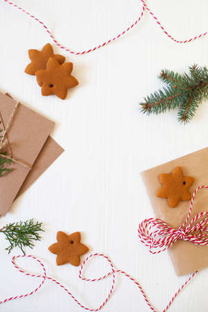 Christmas composition. Xmas cookies, Gingerbread man, ribbon, card, festive decoration, fir branches on white wooden background. Flat lay, top view, with copy space. Close Upの写真素材