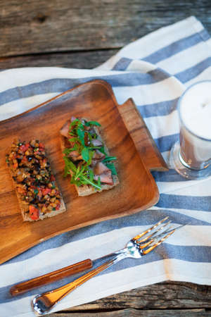 Italian tomato bruschetta with chopped vegetables, herbs and oil on grilled or toasted crusty bread.の写真素材