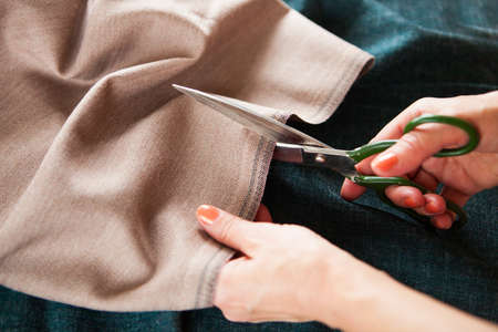Tailor. Woman Hands notch tailor tailor's scissors cloth. Close Up.  の写真素材