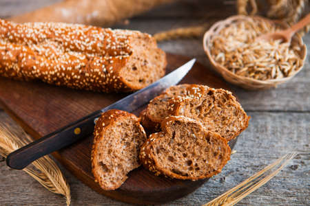Sliced rye bread on a Board. On a wooden table.