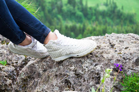 shoes walking an lying hiker front of a mountainous landscape