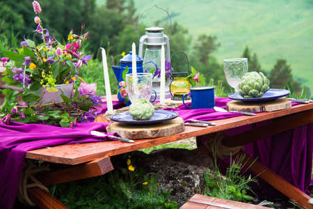 Wedding table setting decorated in rustic style. Wedding inspiration on mountain. Outdoorの写真素材