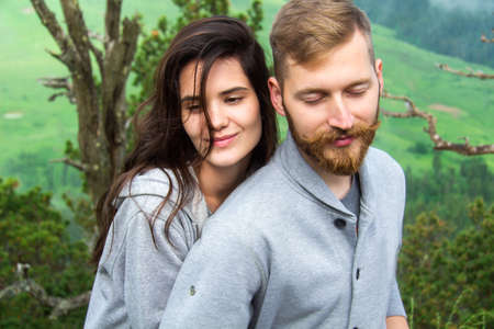 Portrait Happy young Smiling Couple in love, beautiful couple embraces in mountainsの写真素材