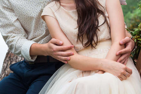 Close up hands Couple in love, gorgeous bride and stylish groom on top, fine art wedding coupleの写真素材