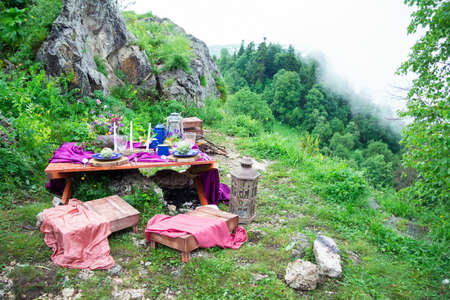 Wedding table setting decorated in rustic style. Wedding inspiration on mountain. Outdoorの写真素材