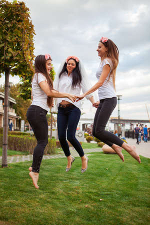 Three beautiful happy women at hen party, girls celebrating a bachelorette party of brideの写真素材