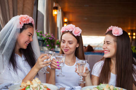 Three happines women with champagne at hen partyの写真素材