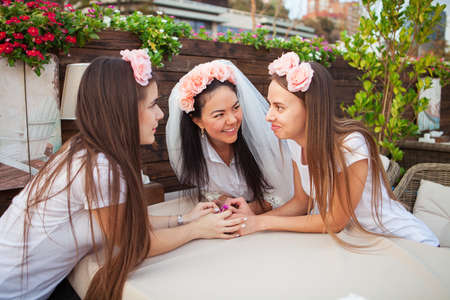 Three beautiful happy women at hen party, girls celebrating a bachelorette party of brideの写真素材