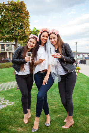 Three happines women with champagne at hen partyの写真素材