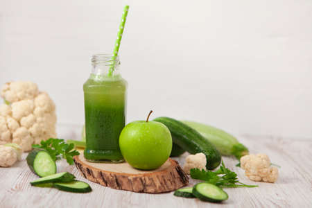 Healthy green vegetables and green fruit smoothie on white backgroundの写真素材