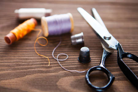 Vintage sewing table with scissors, threads, tailored details
